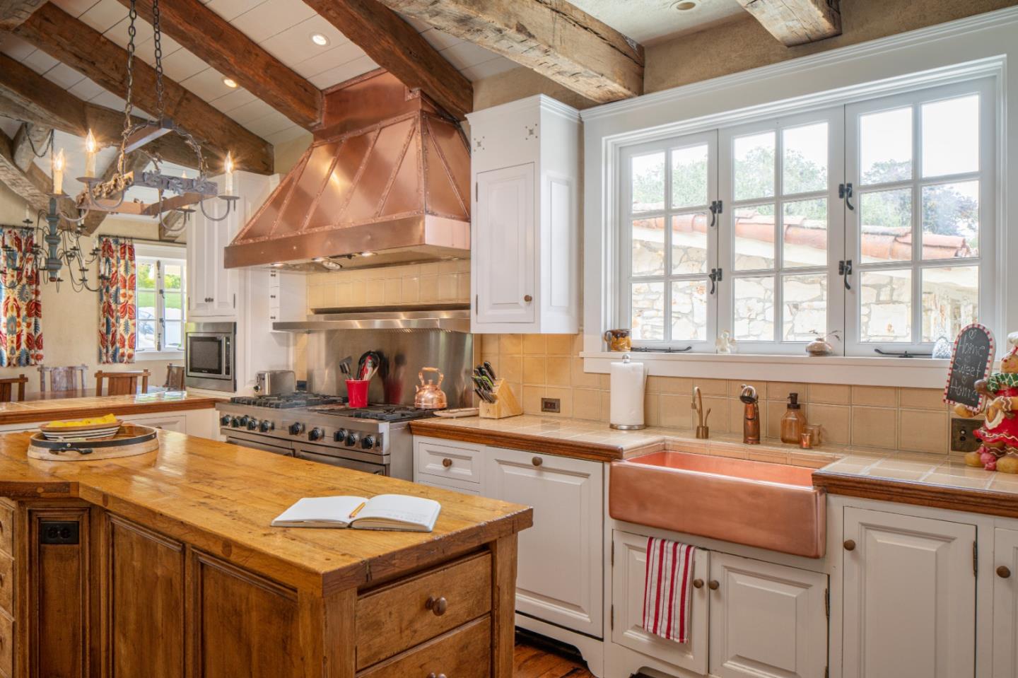 1456 Riata Road Pebble Beach, CA 93953 - Photo 10 of 32 a kitchen that has a sink and a stove