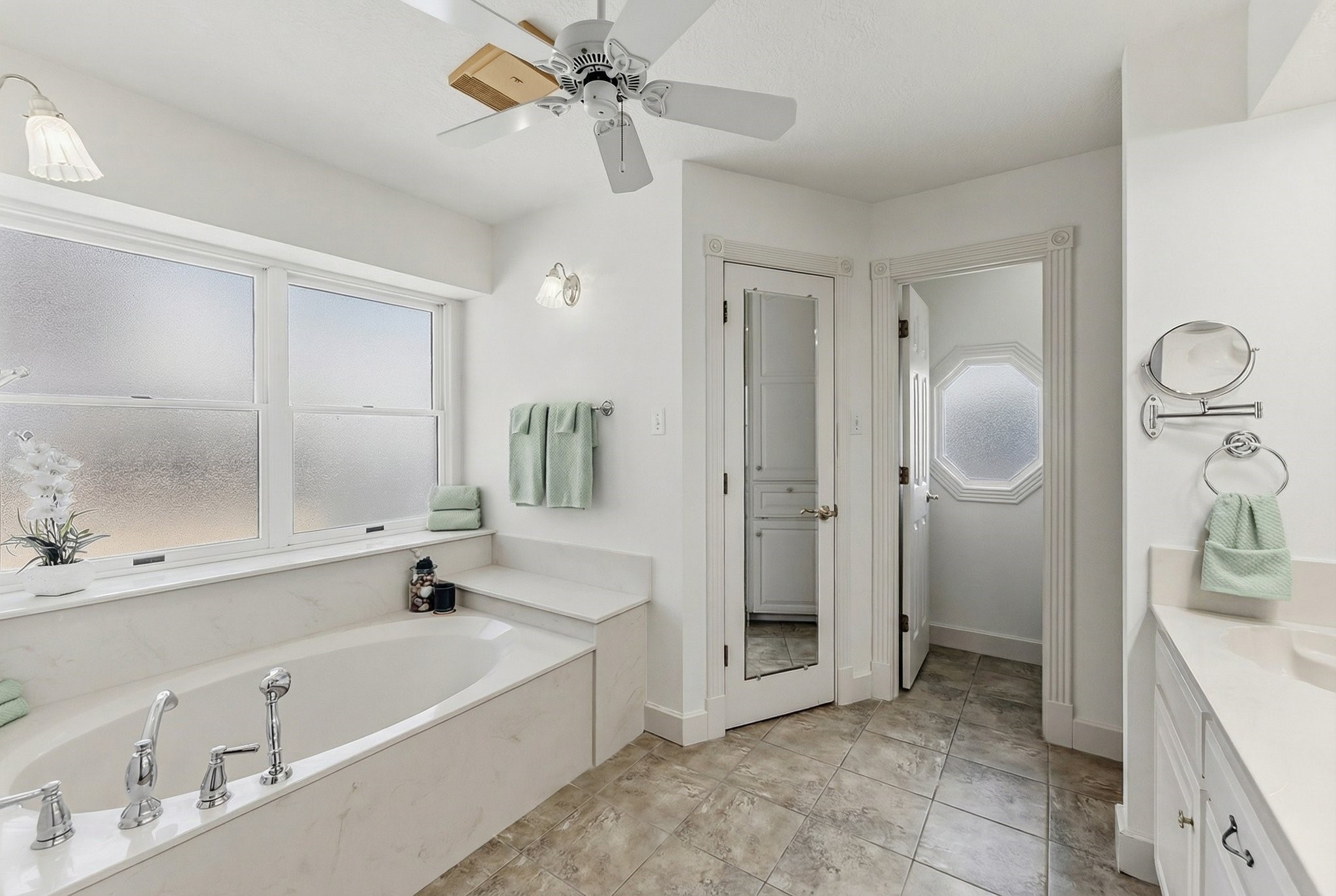 2008 Wickersham Drive Huntsville, TX 77340 - Photo 24 of 44 a bathroom with a tub a sink and a large mirror