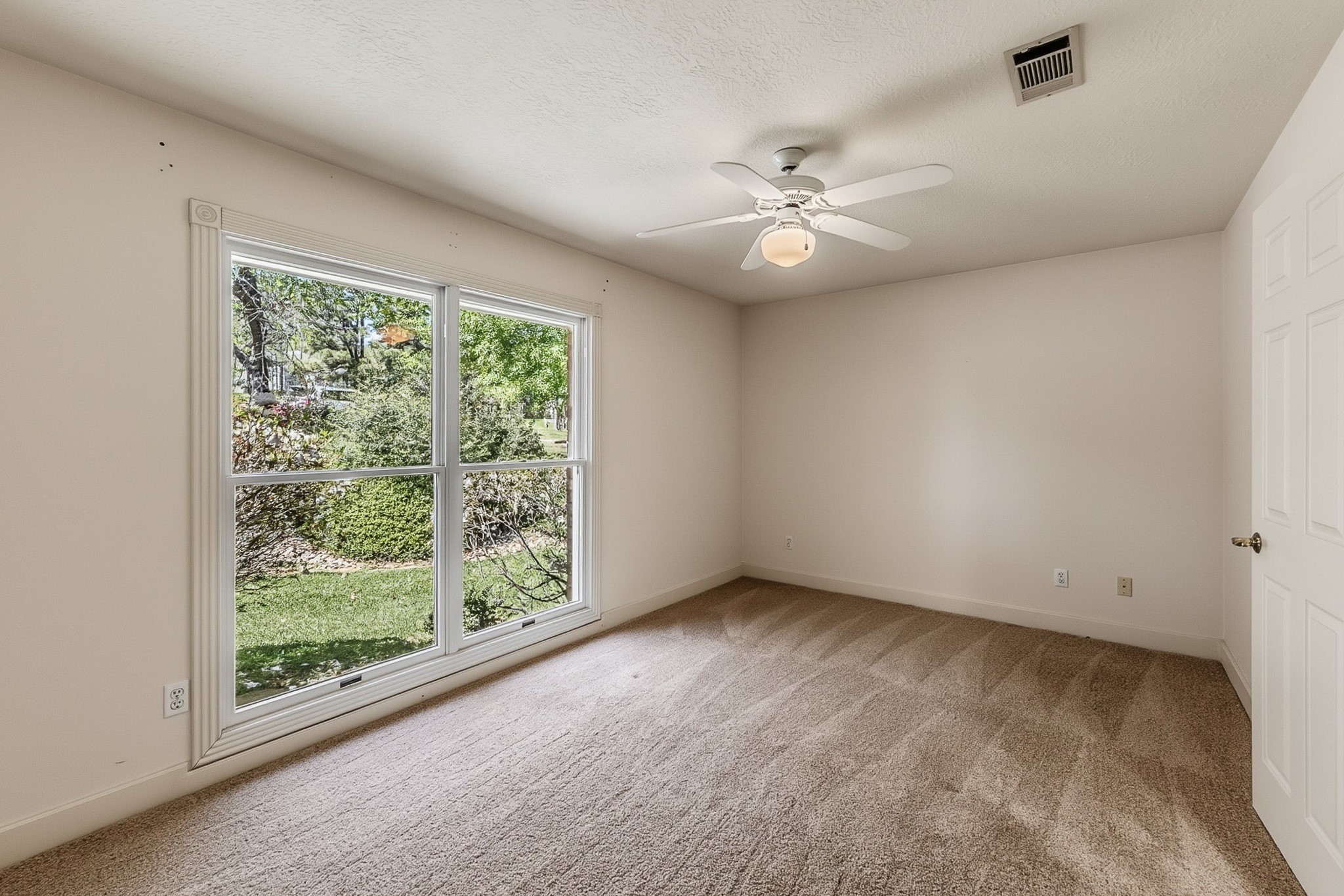 2008 Wickersham Drive Huntsville, TX 77340 - Photo 28 of 44 an empty room with a large window with ceiling fan