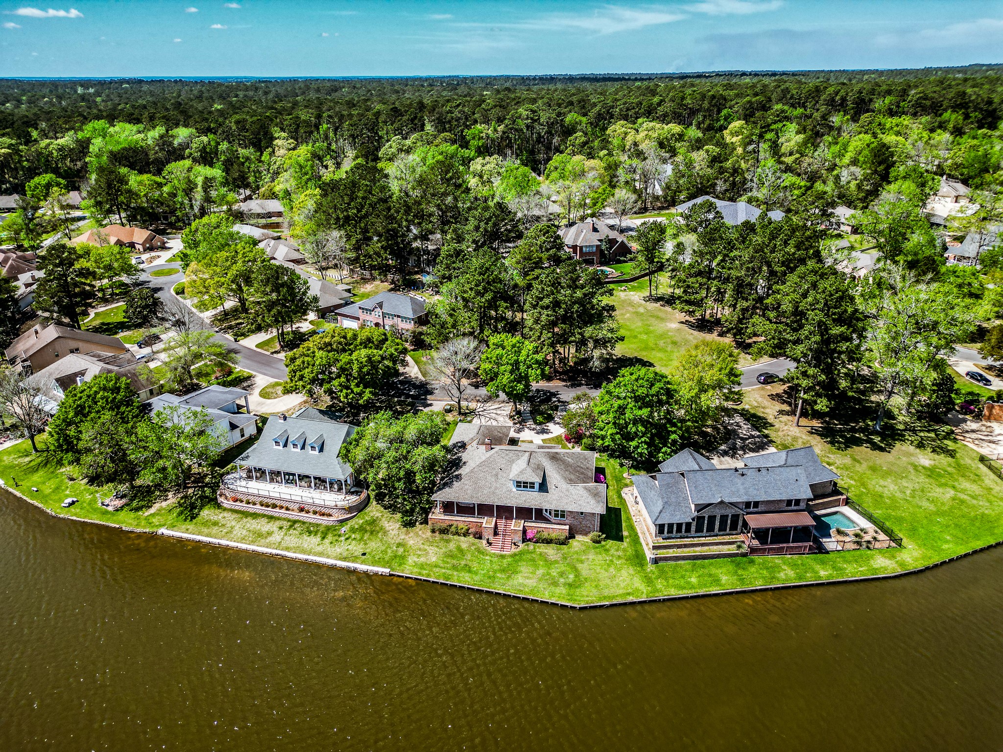 2008 Wickersham Drive Huntsville, TX 77340 - Photo 5 of 44 an aerial view of a house with a garden and lake view