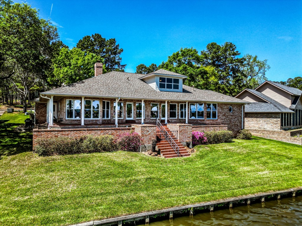 2008 Wickersham Drive Huntsville, TX 77340 - Photo 6 of 44 a front view of a house with a yard table and chairs