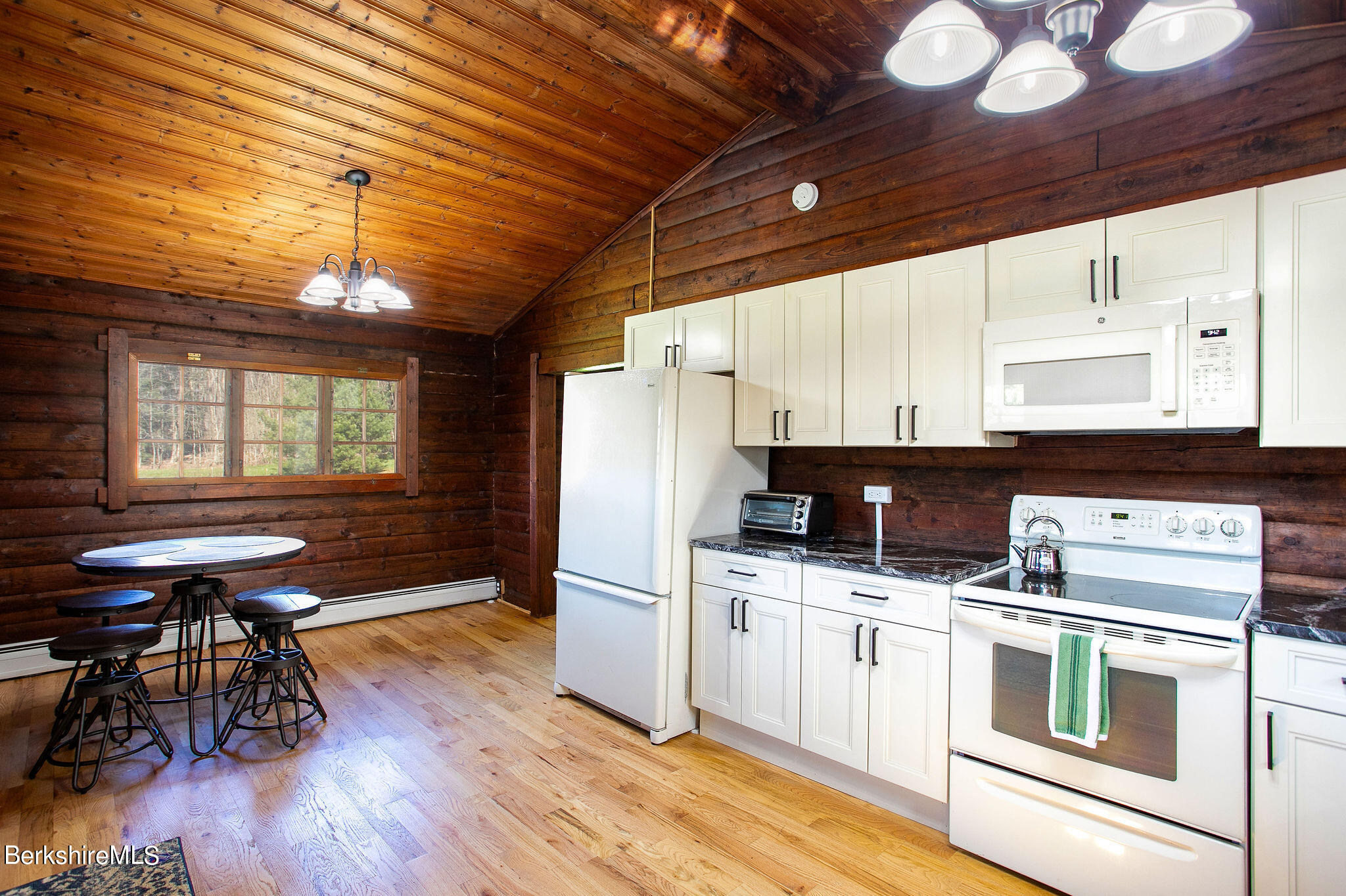 2184 Monterey Road Otis, MA 01253 - Photo 16 of 32 a kitchen with granite countertop a stove a sink dishwasher and white refrigerator with wooden floor