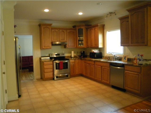 8800 Strath Road Richmond, VA 23231 - Photo 4 of 10 a kitchen with stainless steel appliances granite countertop a stove a sink and a refrigerator