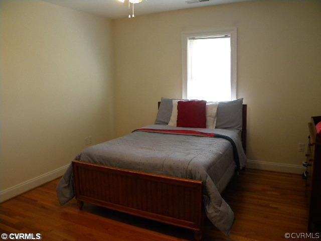 8800 Strath Road Richmond, VA 23231 - Photo 7 of 10 a bed sitting in a bedroom next to a window