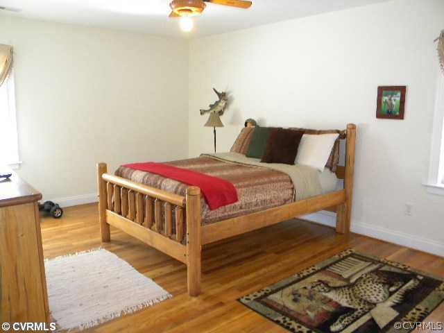8800 Strath Road Richmond, VA 23231 - Photo 8 of 10 a bedroom with a bed and wooden floor