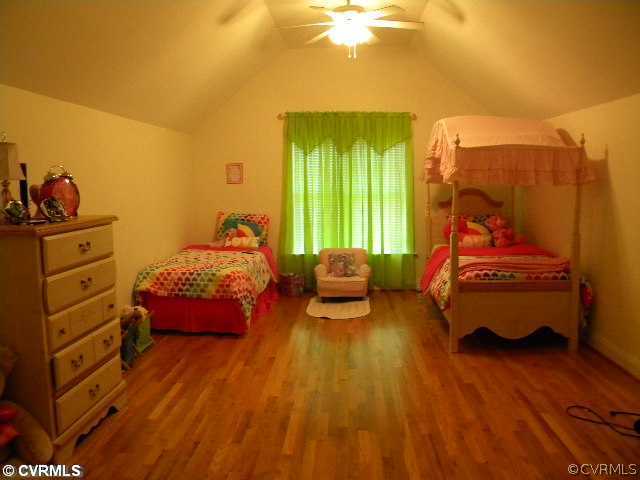 8800 Strath Road Richmond, VA 23231 - Photo 9 of 10 a bedroom with a bed and a chandelier