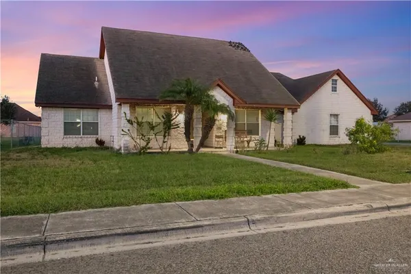 a front view of house with yard and green space