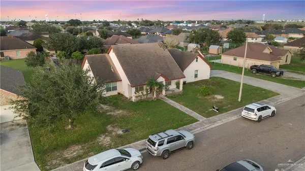 an aerial view of a house with a garden and pool