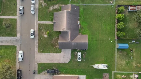 an aerial view of a house with a yard basket ball court and outdoor seating