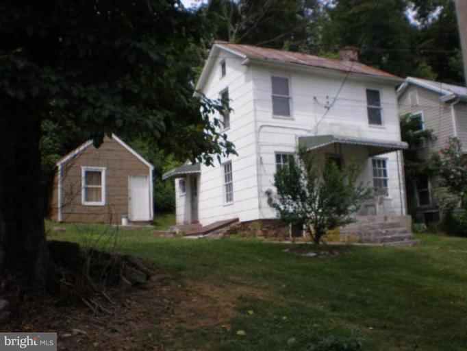 1308 Bruceville Road Keymar, MD 21757 - Photo 1 of 20 a front view of a house with a garden
