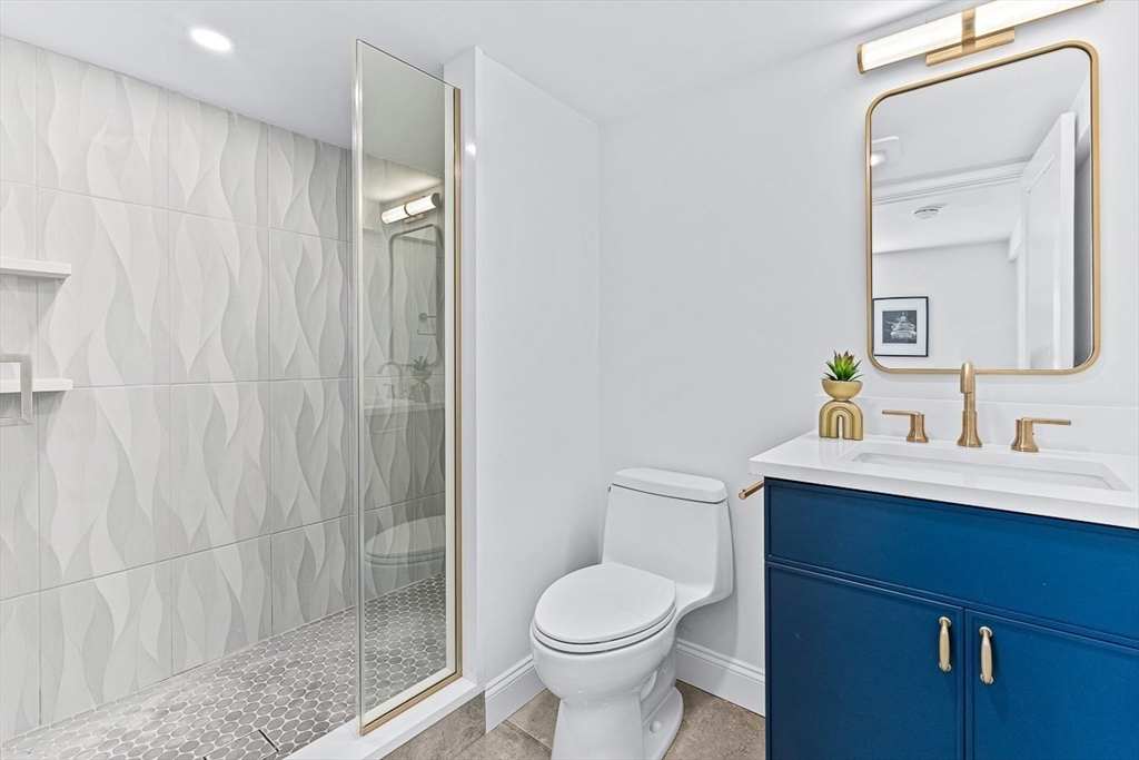 25 Thomas Road Wellesley, MA 02482 - Photo 13 of 27 a bathroom with a sink a toilet and shower