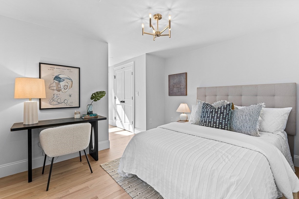 25 Thomas Road Wellesley, MA 02482 - Photo 16 of 27 a bedroom with a bed and a chandelier