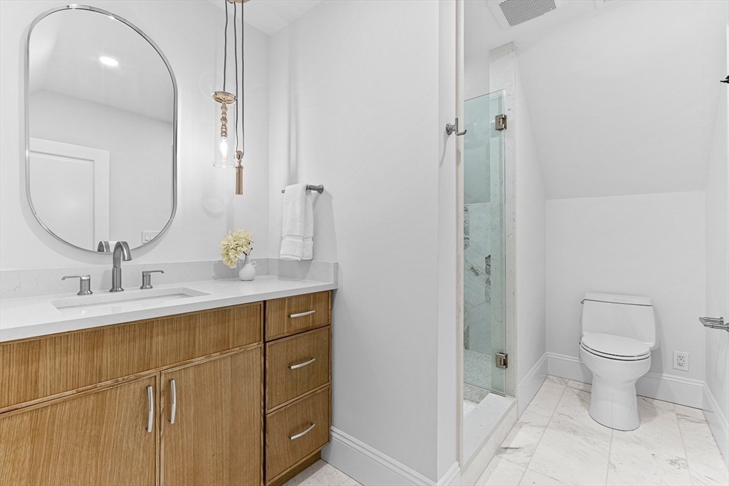 25 Thomas Road Wellesley, MA 02482 - Photo 22 of 27 a bathroom with a double vanity sink toilet and shower