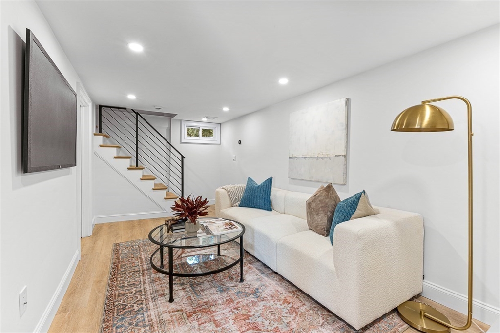 25 Thomas Road Wellesley, MA 02482 - Photo 23 of 27 a living room with furniture and a lamp
