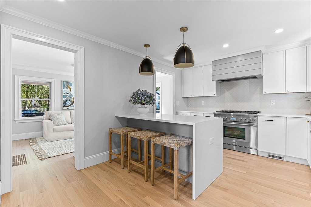 25 Thomas Road Wellesley, MA 02482 - Photo 5 of 27 a kitchen with granite countertop a stove a sink and a refrigerator