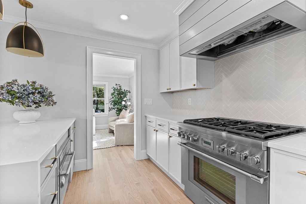 25 Thomas Road Wellesley, MA 02482 - Photo 6 of 27 a kitchen with a stove and white cabinets
