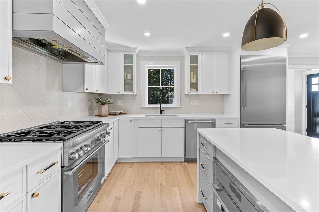 25 Thomas Road Wellesley, MA 02482 - Photo 7 of 27 a kitchen with a sink stove and cabinets