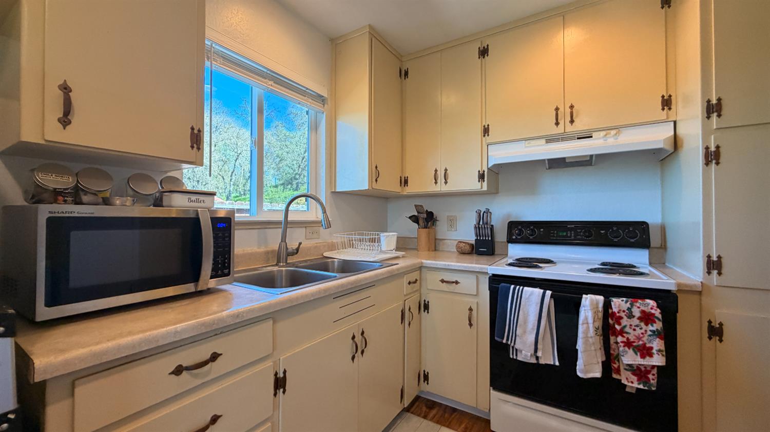 553 Russells Road San Andreas, CA 95249 - Photo 14 of 31 a kitchen with stainless steel appliances a sink a stove and white cabinets