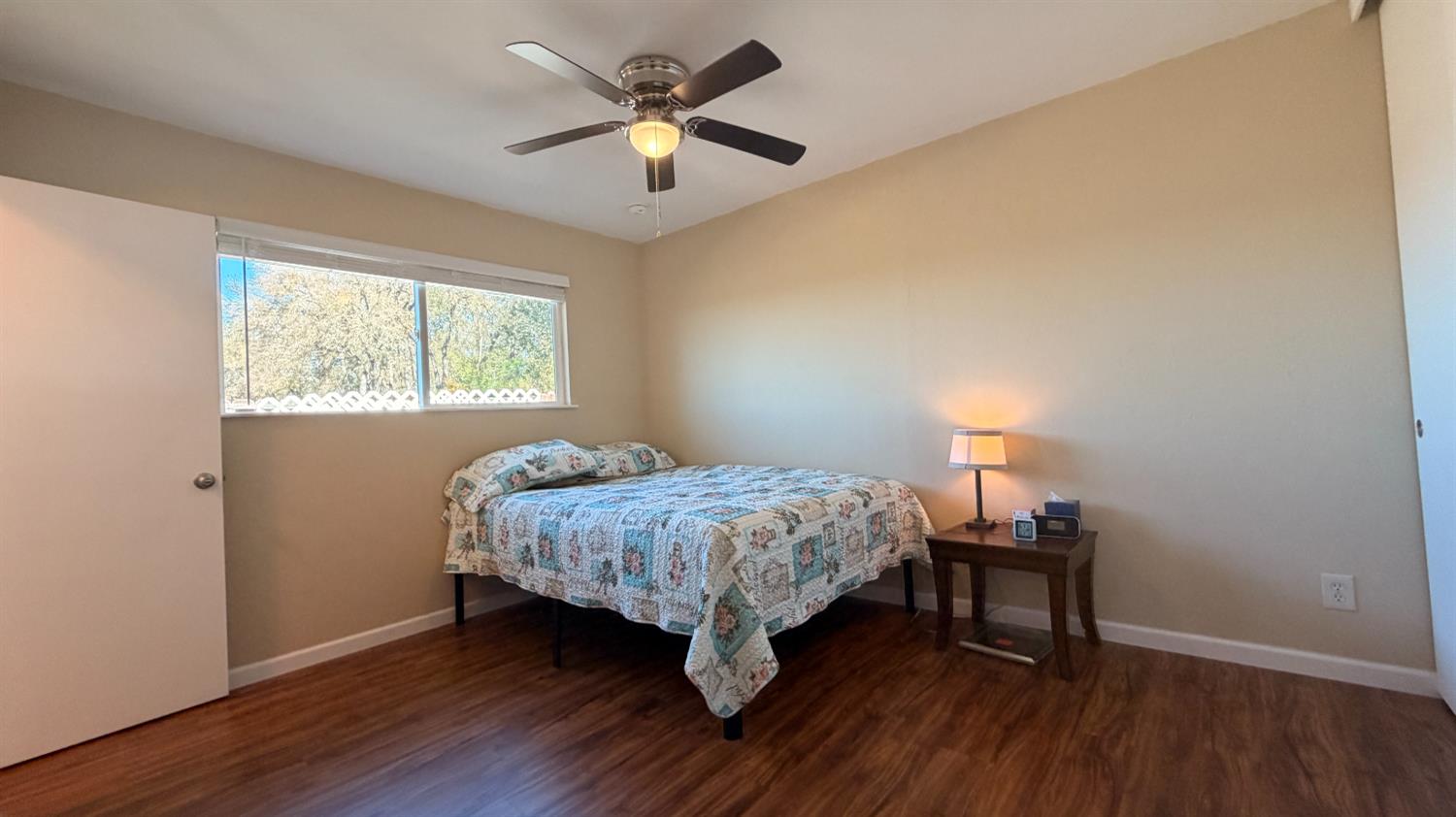 553 Russells Road San Andreas, CA 95249 - Photo 17 of 31 a bedroom with a bed and a chandelier