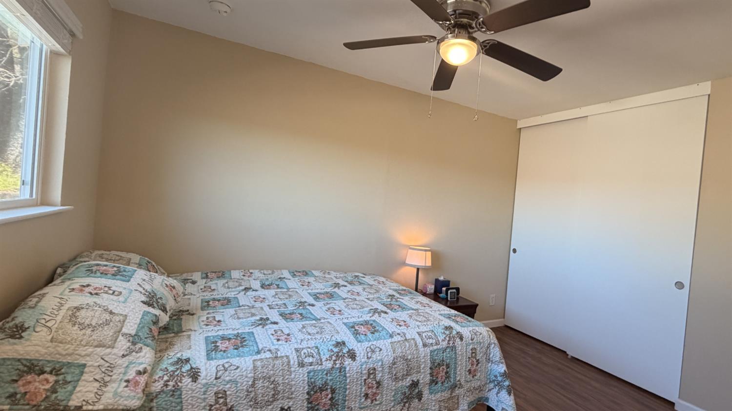 553 Russells Road San Andreas, CA 95249 - Photo 19 of 31 a bedroom with a bed and a chandelier