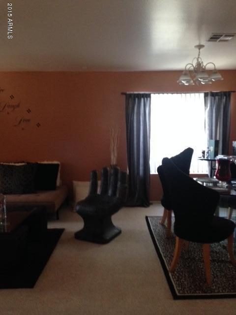 4134 West Vineyard Road Phoenix, AZ 85041 - Photo 3 of 7 a table and chairs in a room