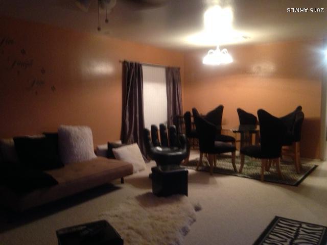 4134 West Vineyard Road Phoenix, AZ 85041 - Photo 6 of 7 a living room with furniture and a lamp