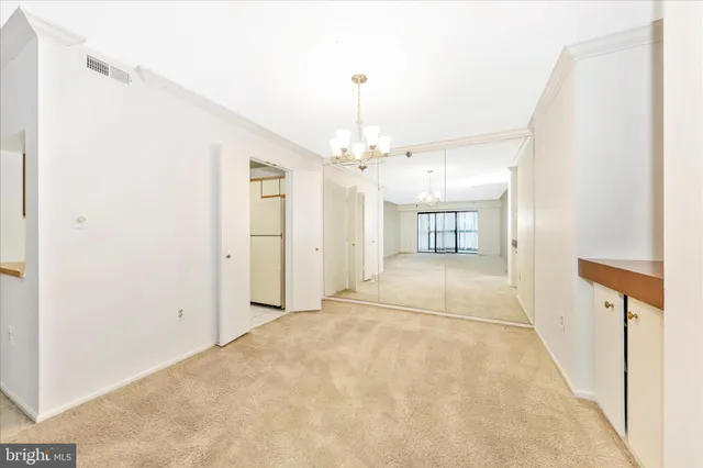 an empty room with windows and cabinet