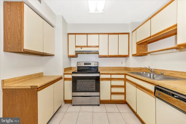 a kitchen with stainless steel appliances granite countertop a sink and a stove