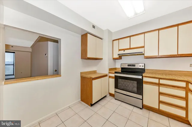 a kitchen with stainless steel appliances a stove sink and cabinets