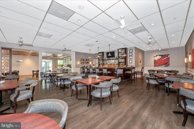 a view of a patio with couches chairs with wooden fence