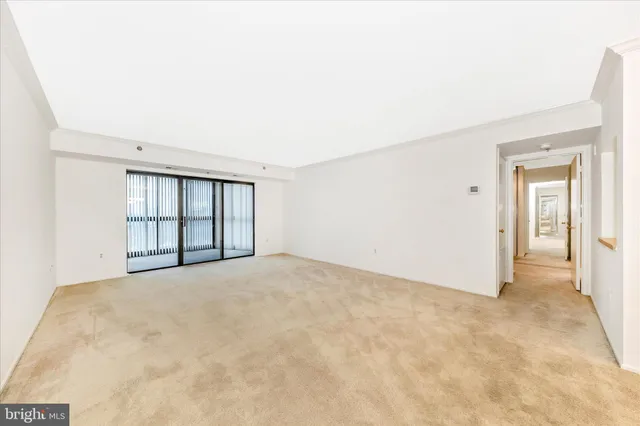 a view of empty room with wooden floor and cabinet