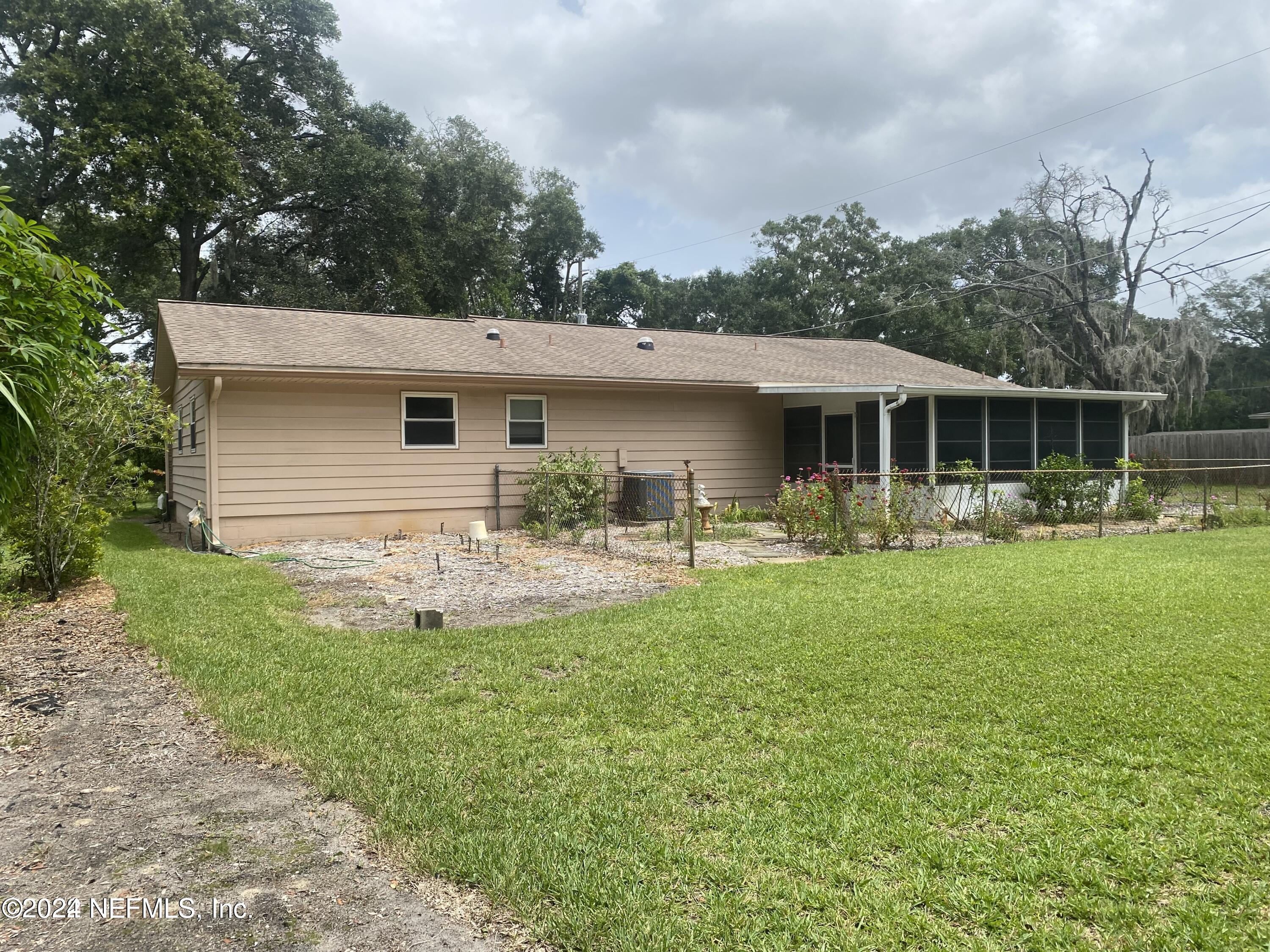 1328 Clements Road Jacksonville, FL 32211 - Photo 15 of 17 a front view of a house with swimming pool and garden