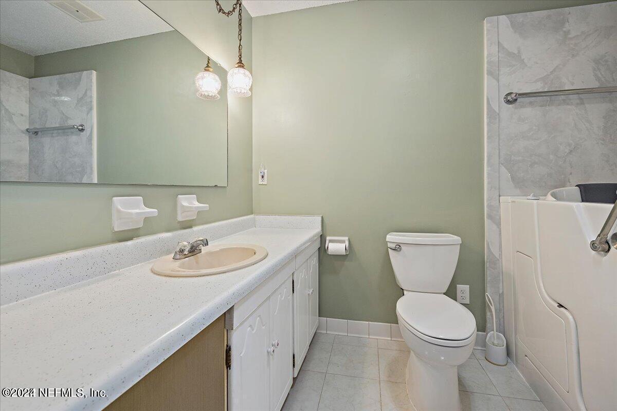 1328 Clements Road Jacksonville, FL 32211 - Photo 6 of 17 a bathroom with a sink toilet and mirror
