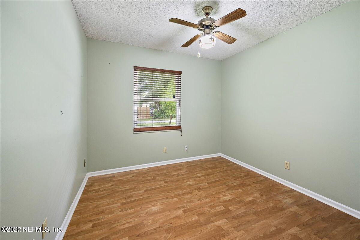 1328 Clements Road Jacksonville, FL 32211 - Photo 8 of 17 an empty room with a window and a fan