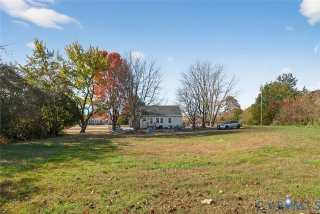 a view of a yard with a house in the background