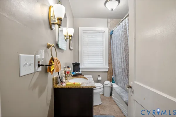 a bathroom with a tub sink and mirror