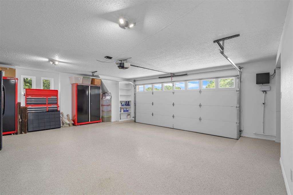 410 Simmons Road Double Oak, TX 75077 - Photo 31 of 40 Oversized garage with generous storage space and epoxy floors.