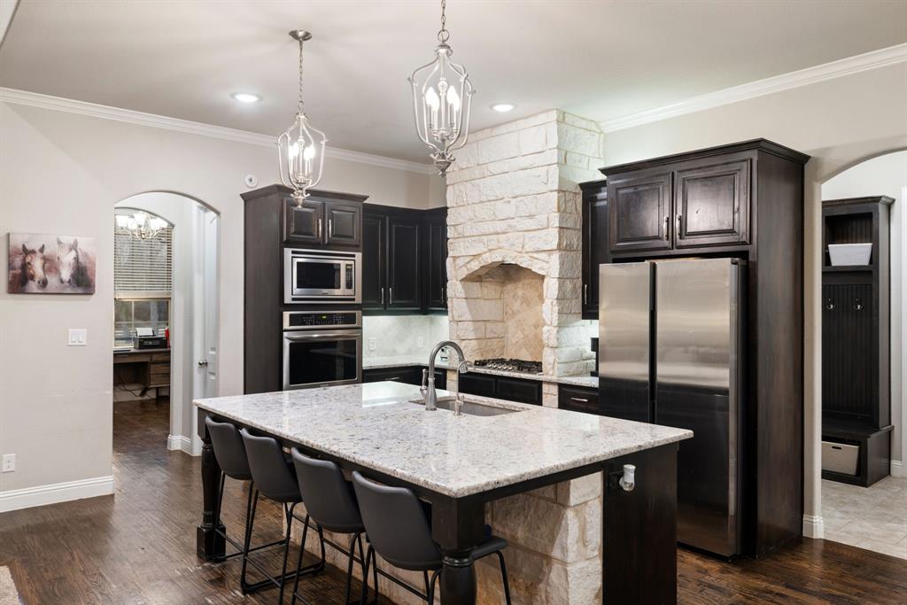 251 Hlavek Road Decatur, TX 76234 - Photo 15 of 33 a kitchen with stainless steel appliances a table chairs refrigerator and microwave