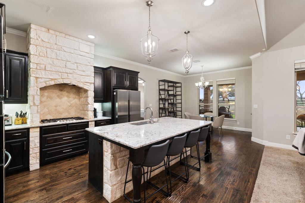 251 Hlavek Road Decatur, TX 76234 - Photo 17 of 33 a kitchen with stainless steel appliances granite countertop a kitchen island a stove and a refrigerator