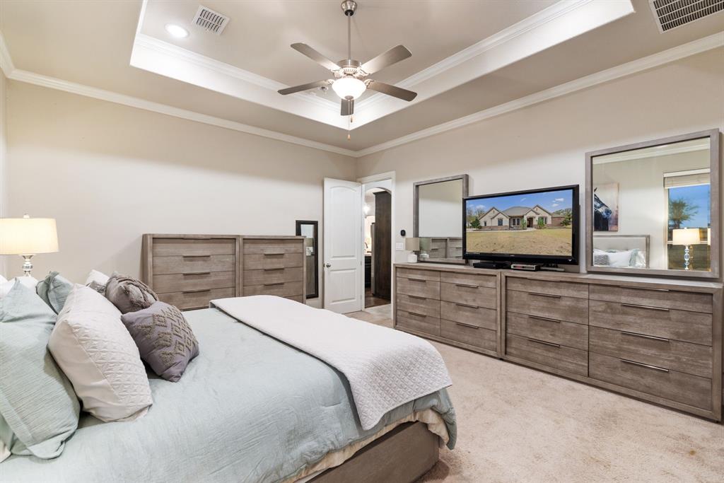 251 Hlavek Road Decatur, TX 76234 - Photo 20 of 33 a bedroom with a large bed and a chandelier