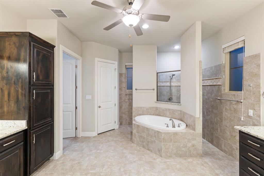 251 Hlavek Road Decatur, TX 76234 - Photo 21 of 33 a bathroom with a bathtub shower sink and mirror