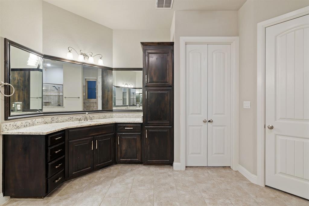 251 Hlavek Road Decatur, TX 76234 - Photo 23 of 33 a bathroom with a granite countertop sink and a mirror