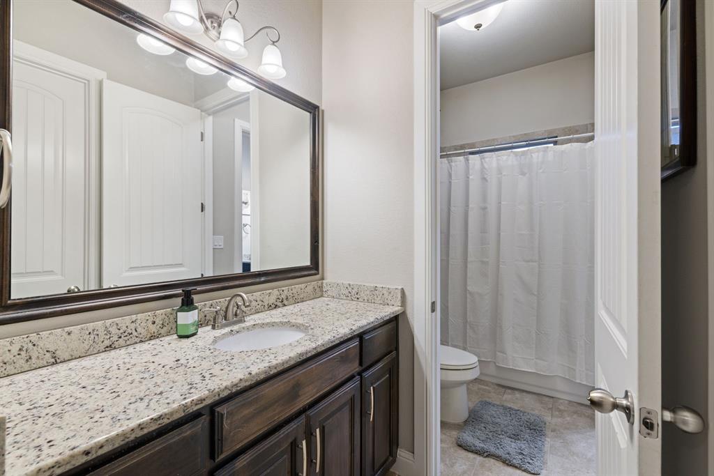 251 Hlavek Road Decatur, TX 76234 - Photo 28 of 33 a bathroom with a granite countertop sink and a mirror