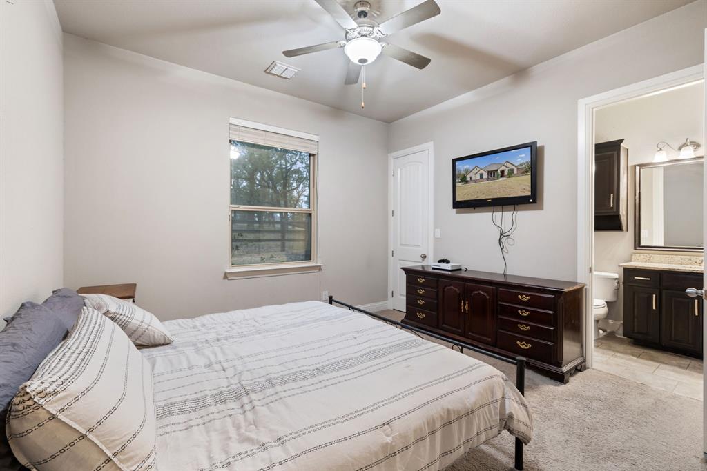 251 Hlavek Road Decatur, TX 76234 - Photo 29 of 33 a bedroom with a bed and a dresser