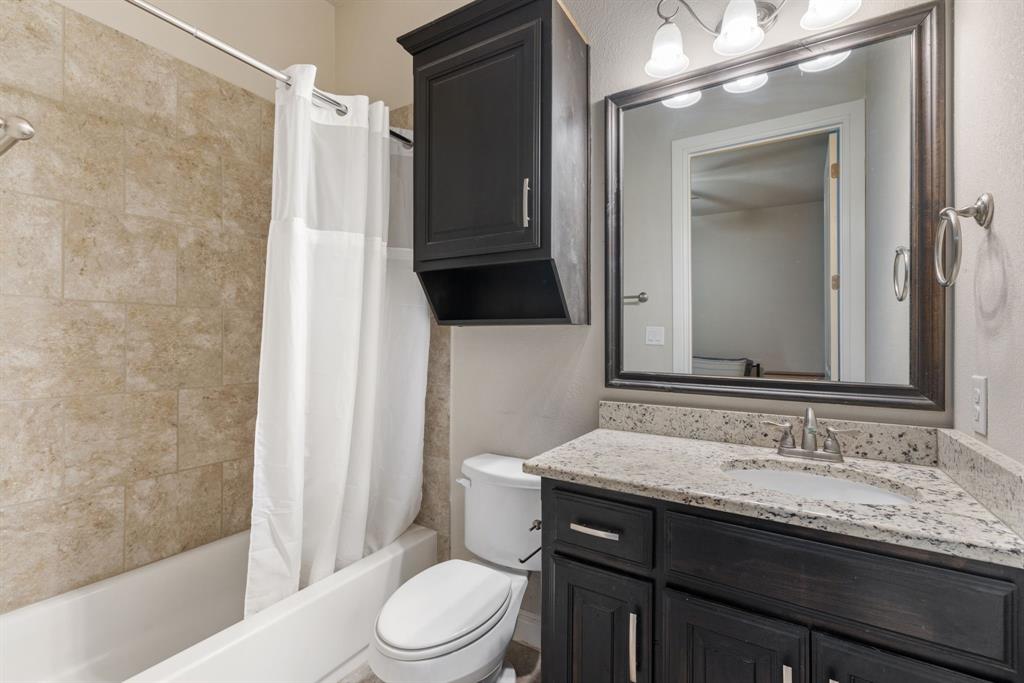 251 Hlavek Road Decatur, TX 76234 - Photo 30 of 33 a bathroom with a granite countertop sink toilet and shower