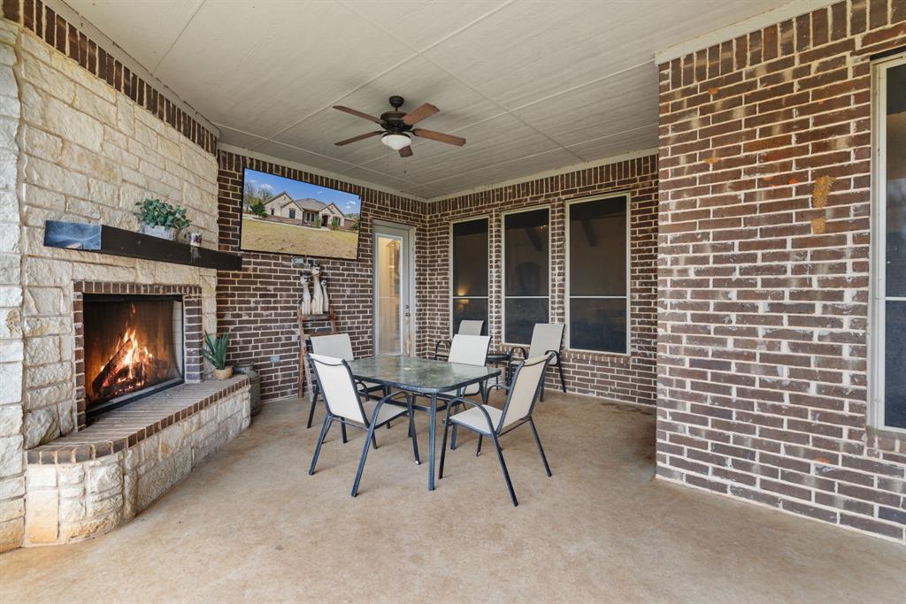 251 Hlavek Road Decatur, TX 76234 - Photo 33 of 33 a dining room with furniture and a fireplace