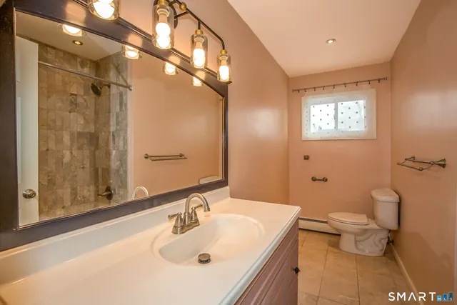 a bathroom with a sink toilet and shower