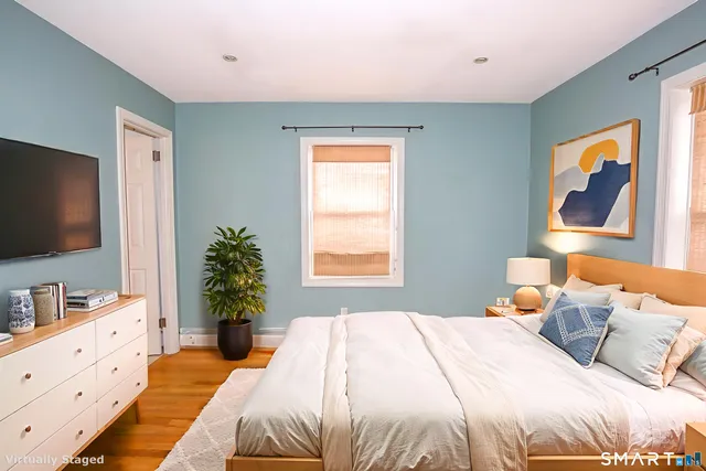 a bedroom with a bed and a flat screen tv