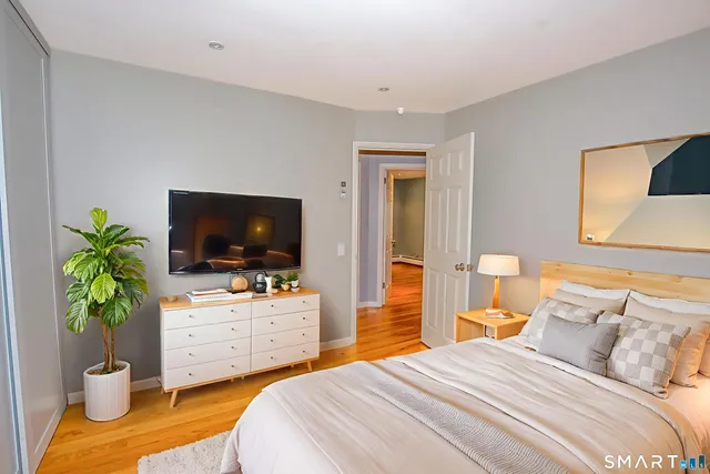 a bedroom with a bed and a flat screen tv