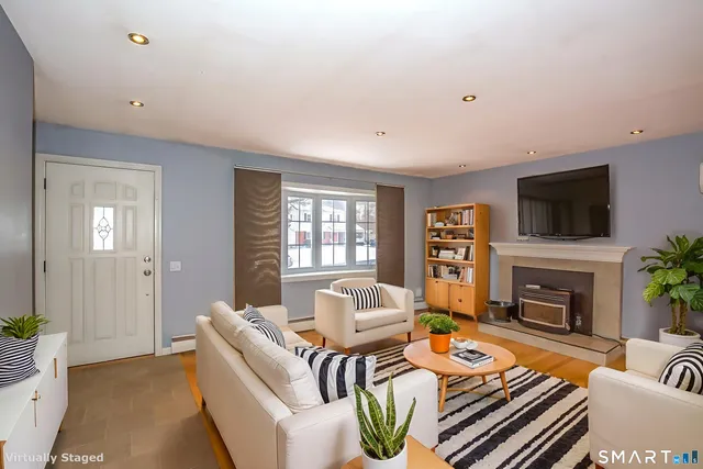 a living room with fireplace furniture and a flat screen tv
